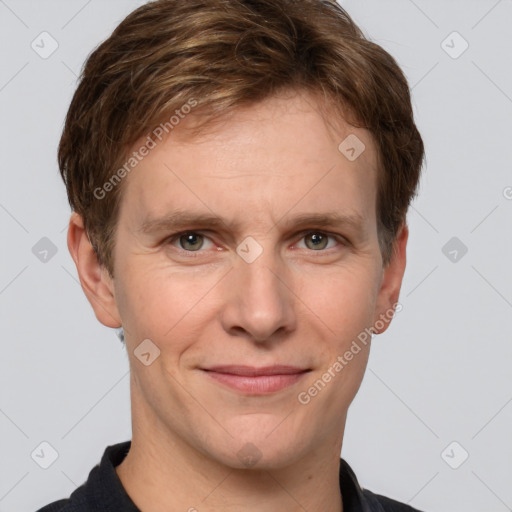 Joyful white adult male with short  brown hair and grey eyes