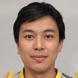 Joyful asian young-adult male with short  brown hair and brown eyes