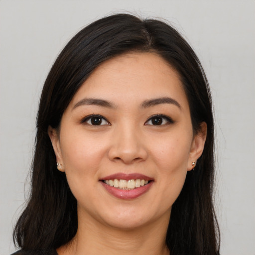 Joyful white young-adult female with long  brown hair and brown eyes