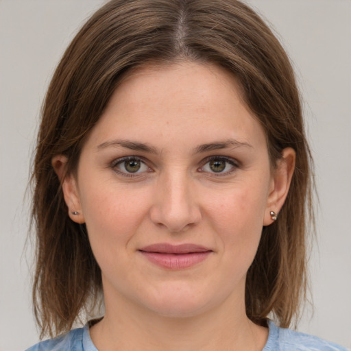 Joyful white young-adult female with medium  brown hair and grey eyes