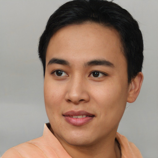 Joyful asian young-adult male with short  black hair and brown eyes