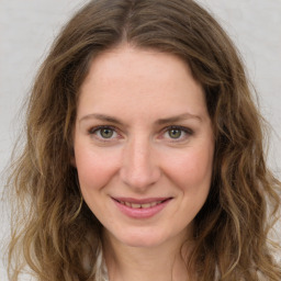 Joyful white young-adult female with long  brown hair and green eyes