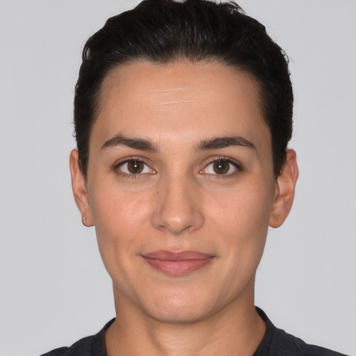 Joyful white young-adult female with short  black hair and brown eyes