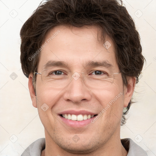 Joyful white adult male with short  brown hair and grey eyes