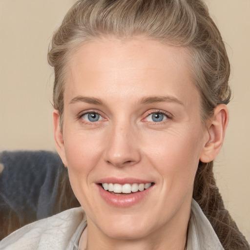 Joyful white adult female with medium  brown hair and grey eyes