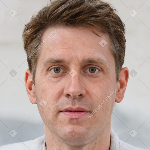 Joyful white adult male with short  brown hair and grey eyes