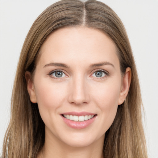 Joyful white young-adult female with long  brown hair and grey eyes