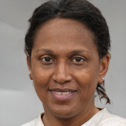 Joyful black adult female with short  brown hair and brown eyes