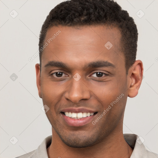 Joyful black young-adult male with short  brown hair and brown eyes