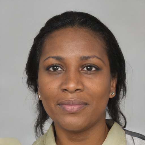 Joyful black adult female with medium  black hair and brown eyes