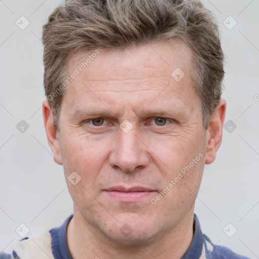 Joyful white adult male with short  brown hair and grey eyes