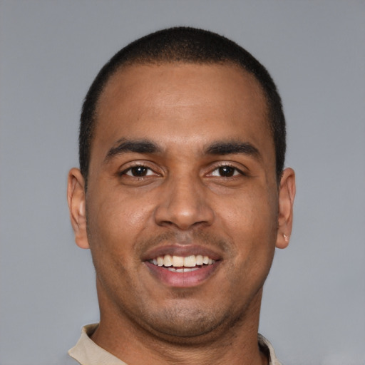 Joyful latino young-adult male with short  brown hair and brown eyes