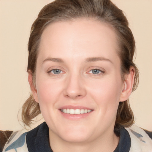 Joyful white young-adult female with medium  brown hair and blue eyes