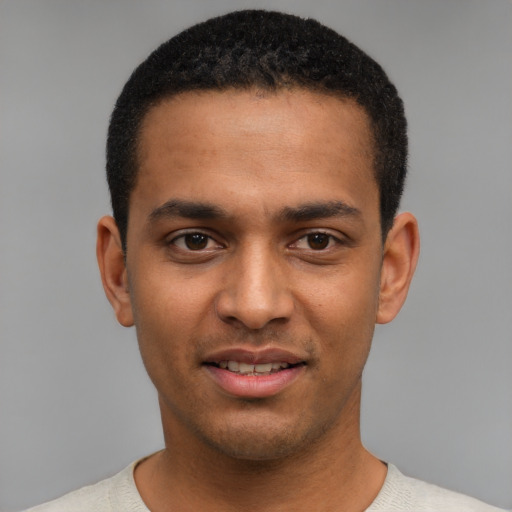 Joyful black young-adult male with short  black hair and brown eyes
