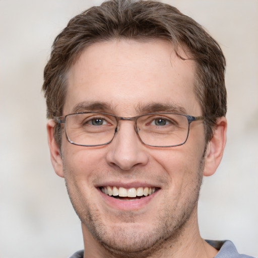 Joyful white adult male with short  brown hair and grey eyes