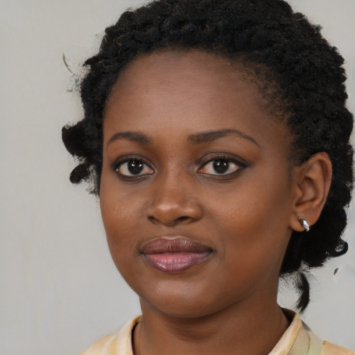 Joyful black young-adult female with medium  black hair and brown eyes