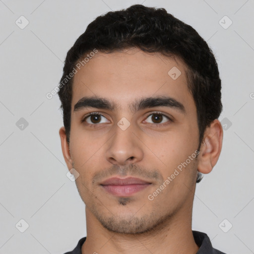 Neutral latino young-adult male with short  black hair and brown eyes