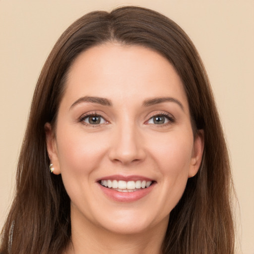 Joyful white young-adult female with long  brown hair and brown eyes