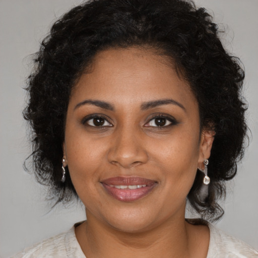 Joyful black young-adult female with medium  brown hair and brown eyes