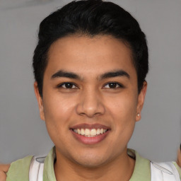 Joyful latino young-adult male with short  brown hair and brown eyes