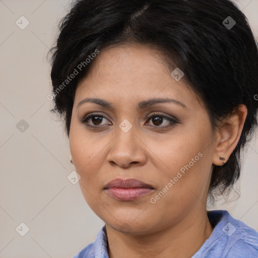 Joyful latino adult female with medium  brown hair and brown eyes