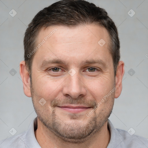 Joyful white adult male with short  brown hair and brown eyes