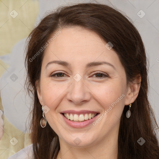 Joyful white adult female with long  brown hair and brown eyes