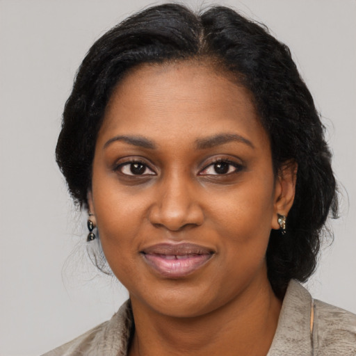 Joyful black young-adult female with medium  black hair and brown eyes