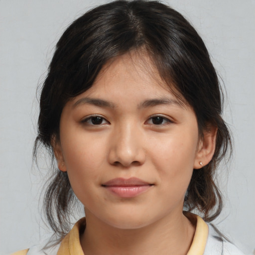 Joyful asian young-adult female with medium  brown hair and brown eyes