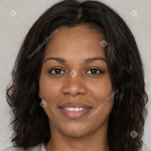 Joyful black young-adult female with long  brown hair and brown eyes