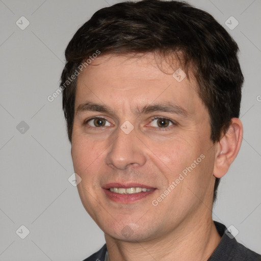 Joyful white adult male with short  brown hair and brown eyes