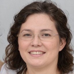 Joyful white adult female with medium  brown hair and brown eyes