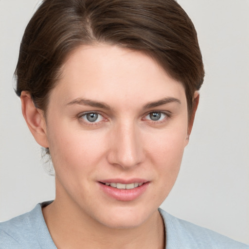 Joyful white young-adult female with short  brown hair and grey eyes