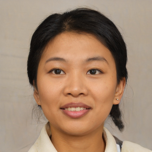 Joyful asian young-adult female with medium  brown hair and brown eyes