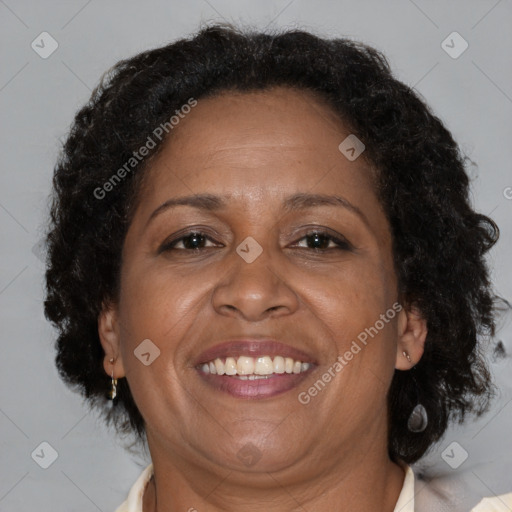 Joyful black adult female with medium  brown hair and brown eyes