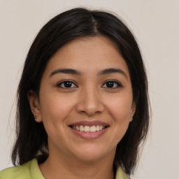 Joyful latino young-adult female with medium  brown hair and brown eyes