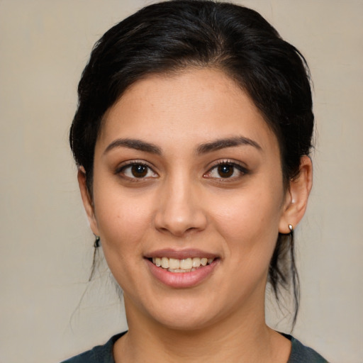 Joyful white young-adult female with medium  black hair and brown eyes