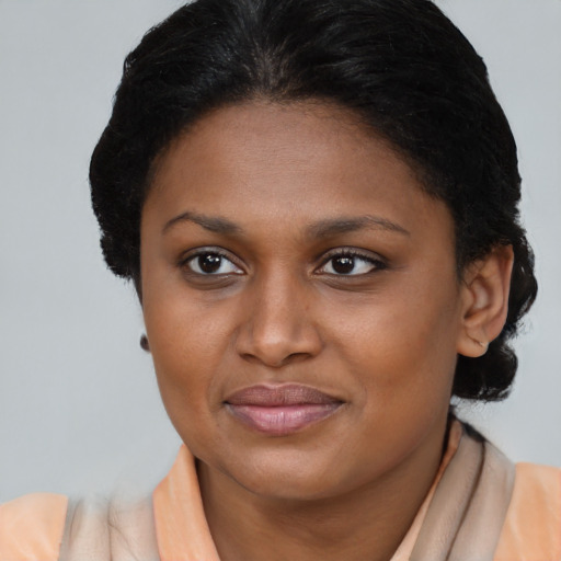 Joyful black young-adult female with short  brown hair and brown eyes