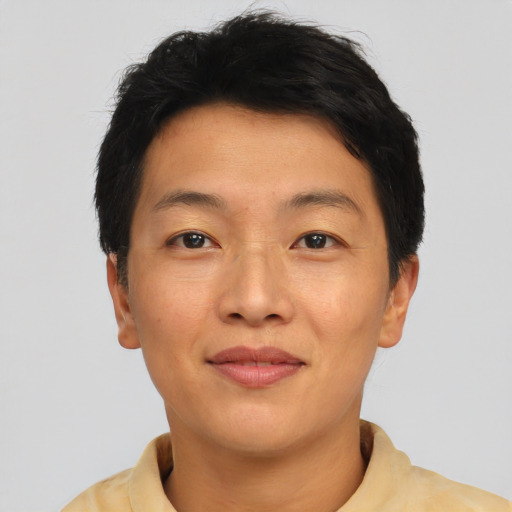 Joyful asian adult female with short  brown hair and brown eyes