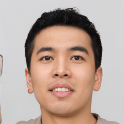Joyful asian young-adult male with short  black hair and brown eyes