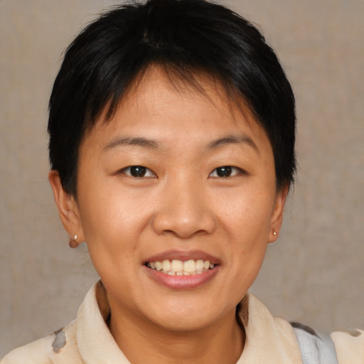 Joyful asian young-adult female with short  brown hair and brown eyes