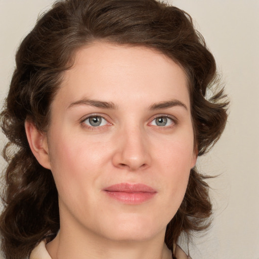 Joyful white young-adult female with medium  brown hair and green eyes