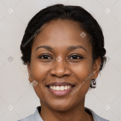 Joyful black adult female with short  brown hair and brown eyes