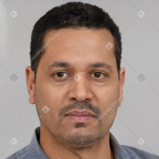 Neutral latino adult male with short  black hair and brown eyes