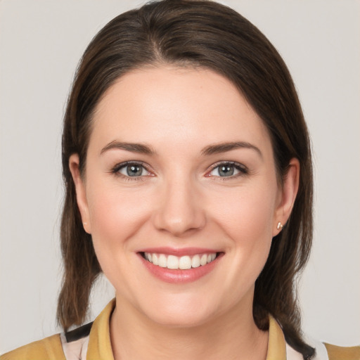 Joyful white young-adult female with medium  brown hair and brown eyes