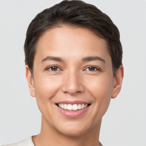 Joyful white young-adult female with short  brown hair and brown eyes