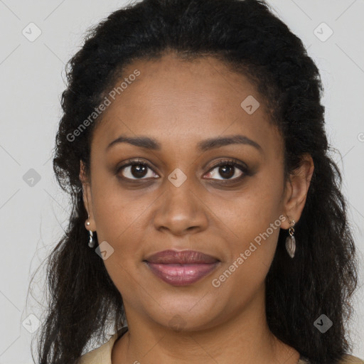 Joyful black young-adult female with long  brown hair and brown eyes