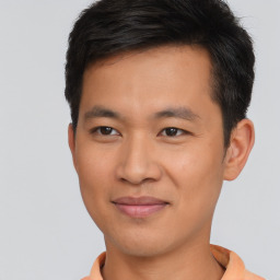 Joyful asian young-adult male with short  brown hair and brown eyes