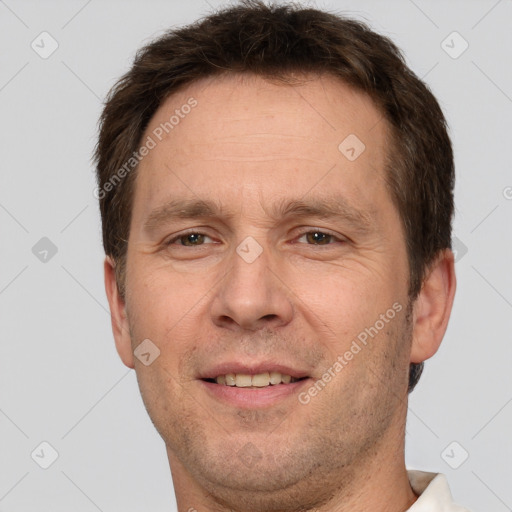 Joyful white adult male with short  brown hair and brown eyes