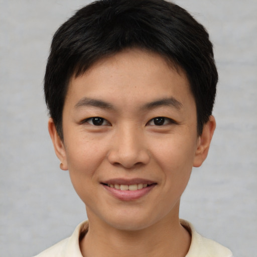 Joyful asian young-adult male with short  brown hair and brown eyes
